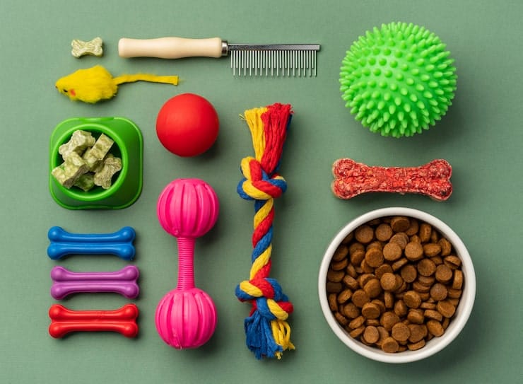 Pet food, treats, toys and grooming supplies laid out neatly